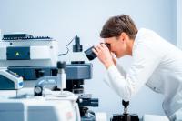 Beneficiary employee working on a microscope